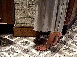 Her sexy feets and pedicured toes in sandals